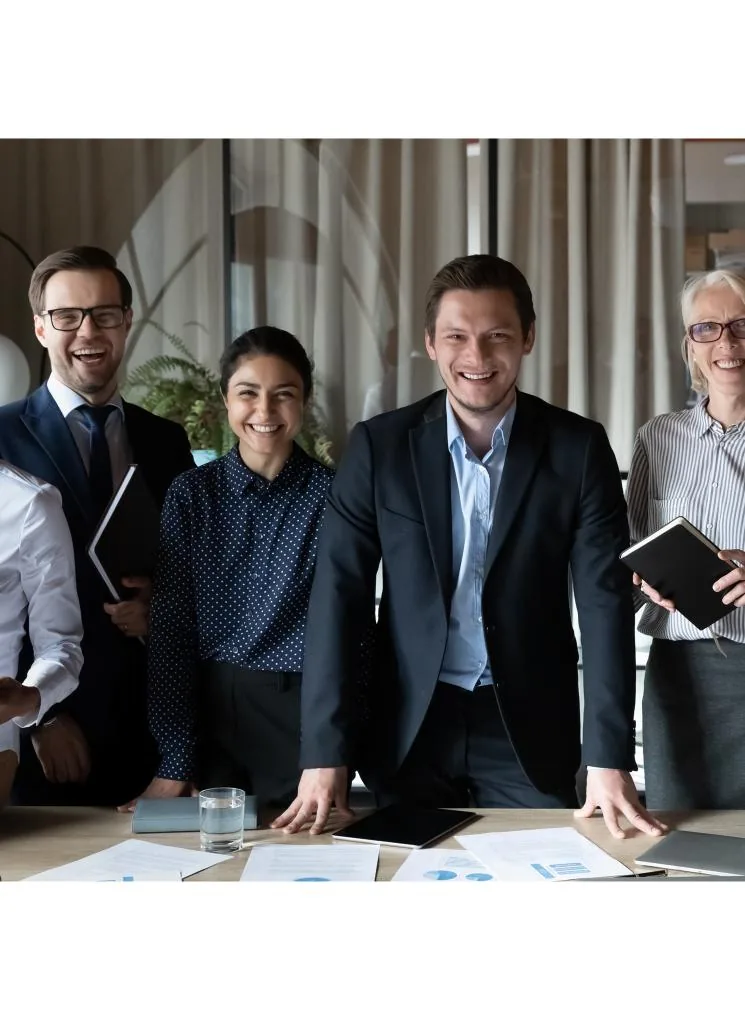 A group of smiling professionals in an office